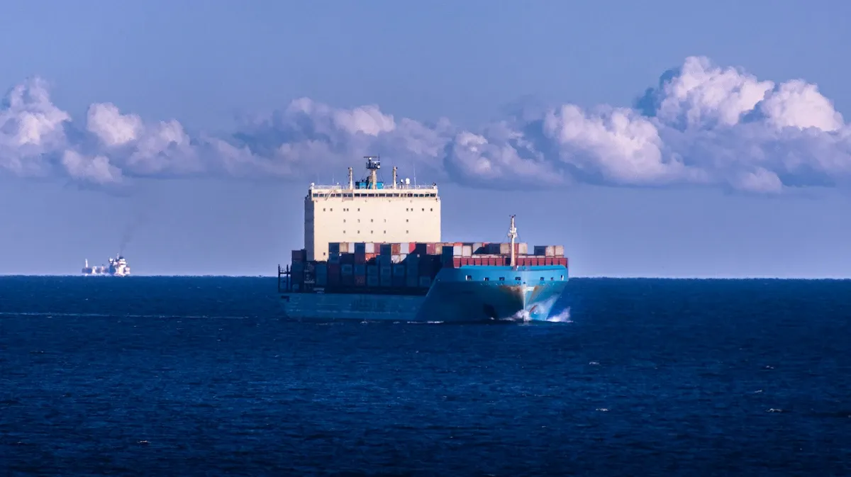 Feeder container vessel navigating at sea showing hull profile and bow wave