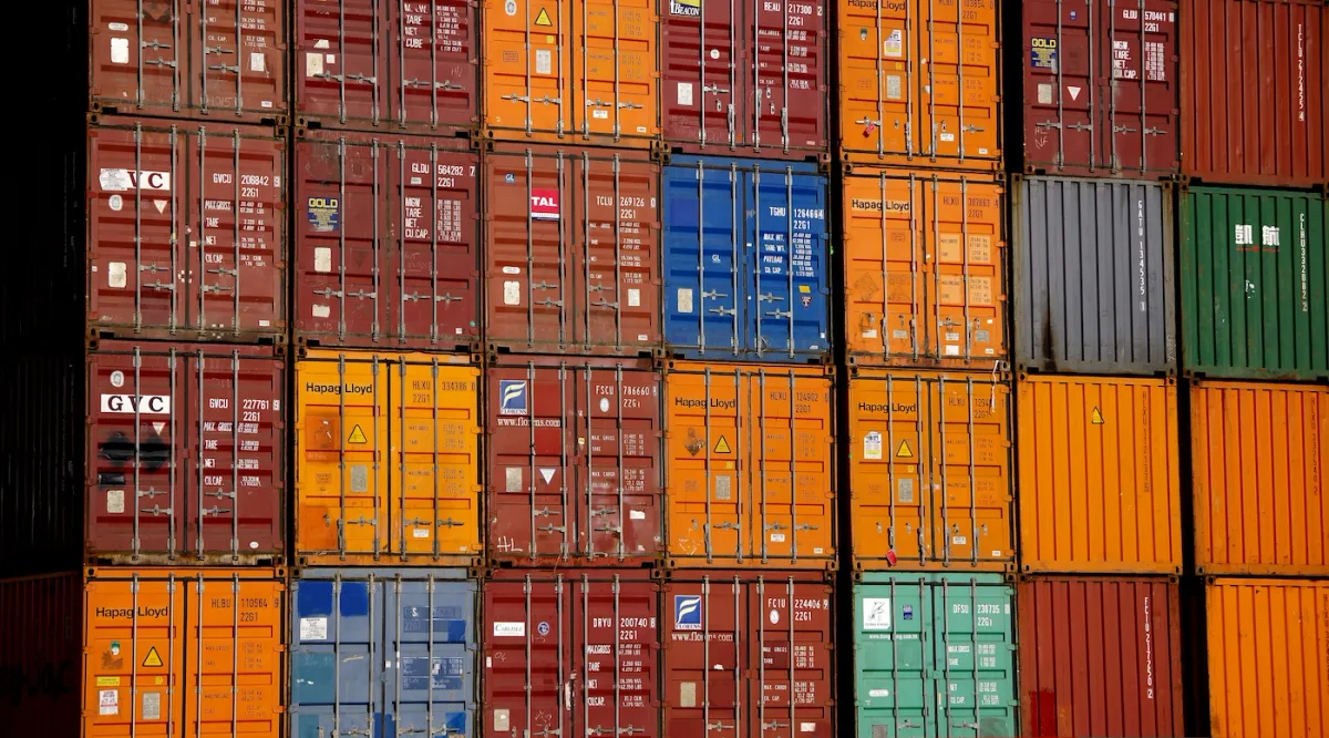 Stacked 20-foot shipping containers from multiple operators showing cargo mix complexity
